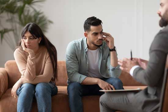sad-couple-sitting-at-therapy-session-in-therapist-2022-01-06-01-24-46-utc
